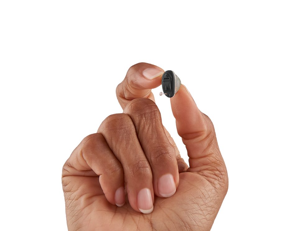 Hand holding completely in canal hearing aid