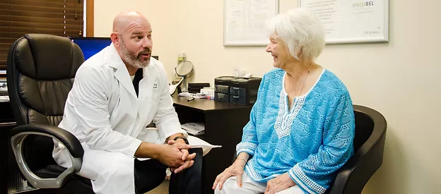 Hearing Instrument Specialist consulting with a patient at Natural Hearing Centers in Hot Springs Village