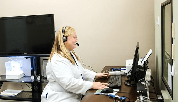 Hearing specialist reviewing patient records at Natural Hearing Centers in Hot Springs, Arkansas