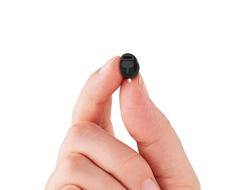 hand holding invisible in canal hearing aid