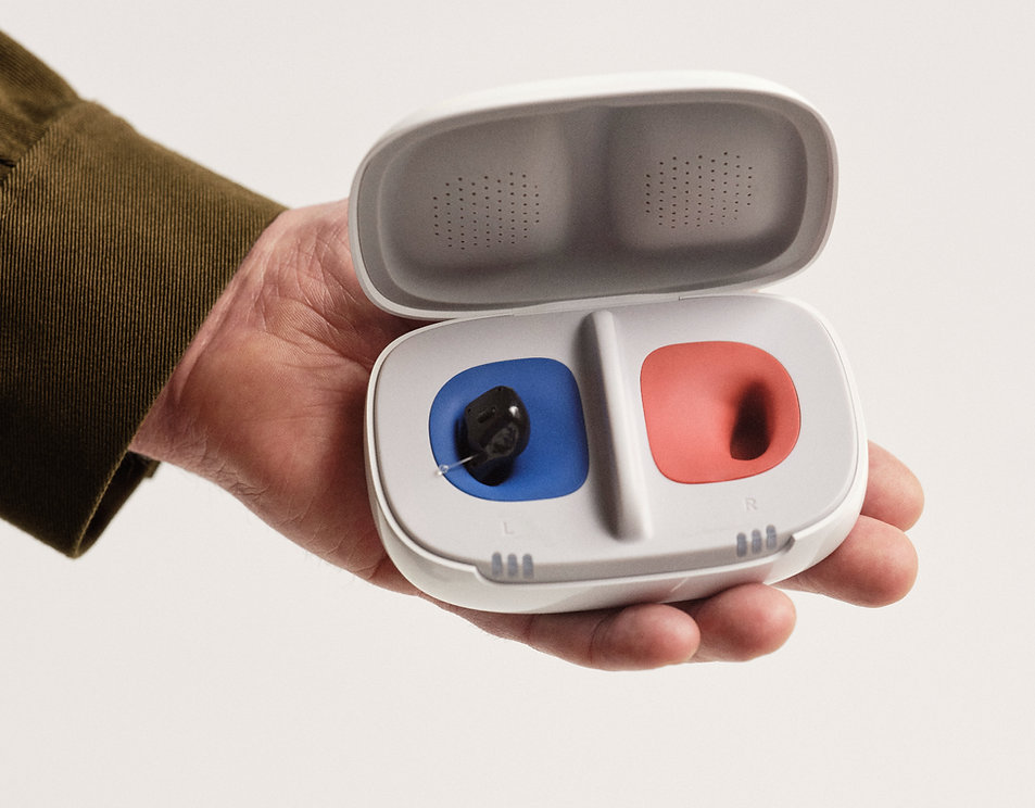 hand holding in the canal hearing aid with charger