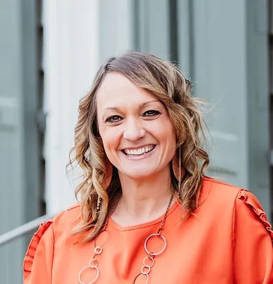Portrait of Rebecca Pfeiffer, Patient Care Coordinator at the Russellville clinic smiling outside the office